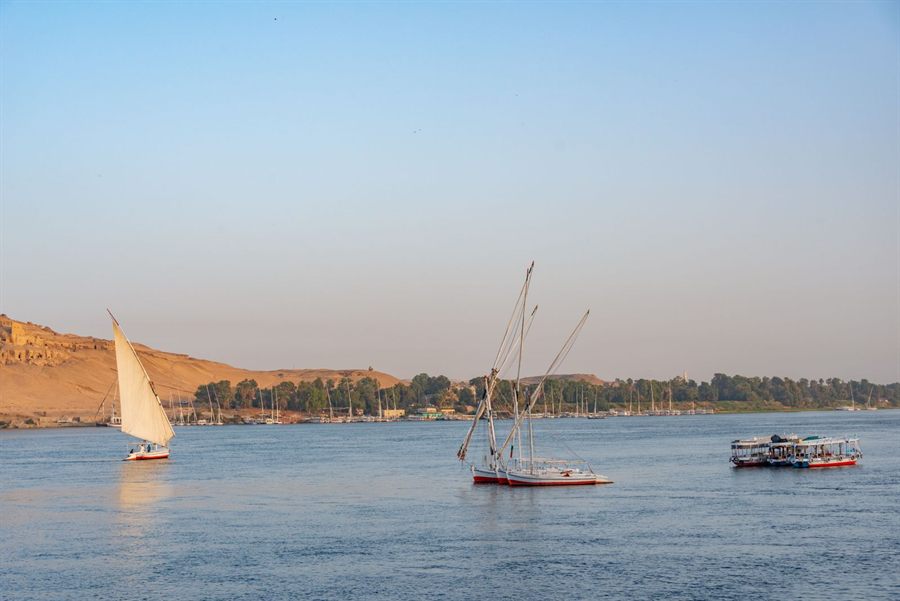 Feluccas sailing on the Nile at Aswan in late-afternoon light