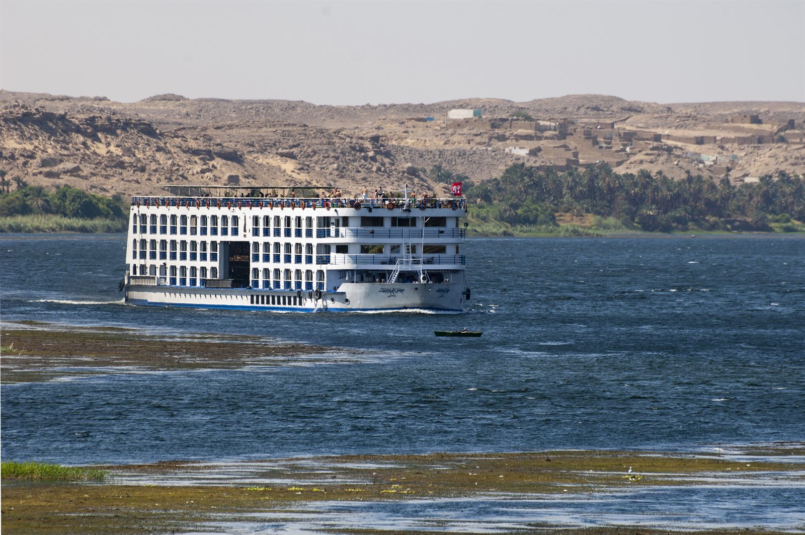 River cruise ship sailing the Nile past desert hills, Egypt river cruises in the 2026 winter season